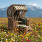 Strandkorb Mr. Deko Düne Bullaugen Teak PE-grey 1-Sitzer mit grün beige kariertem Dessin 506 in Blumenwiese vor Bergen