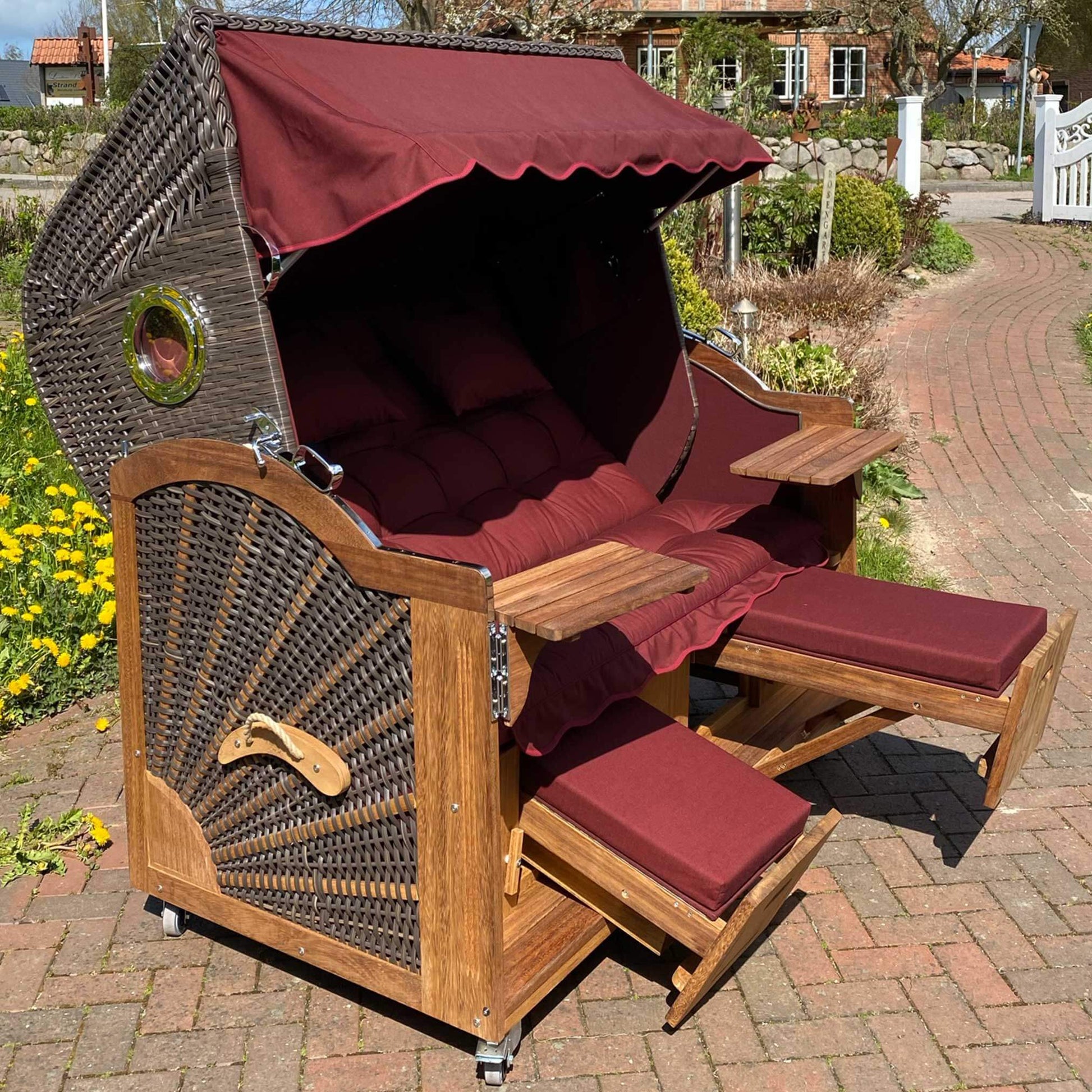 Strandkorb Prieß, Modell Meister aus Iroko Holz mit bordeaux Stoffdessin und PE Geflecht in cappuccino.