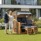 Strandkorb Düne Grande 2,5 Sitzer Teak mit Bullaugen und blauen Polstern im Garten vor modernem Haus