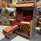 Strandkorb deVries PURE Friesland Sylt Teak PE white kubu mit rot kariertem Dessin und XL-Liegefunktion in Ausstellungshalle