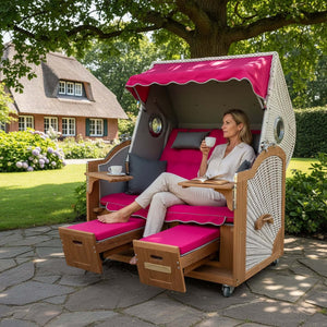Strandkorb Prieß - Fachhandel Modell Meister aus Iroko-Holz mit pinkem Polster und weißem PE-Geflecht im Garten