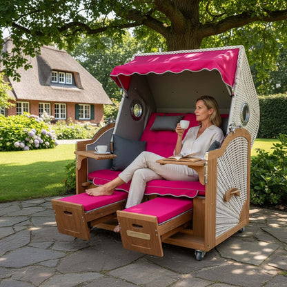 Strandkorb Prieß - Fachhandel Modell Meister aus Iroko-Holz mit pinkem Polster und weißem PE-Geflecht im Garten